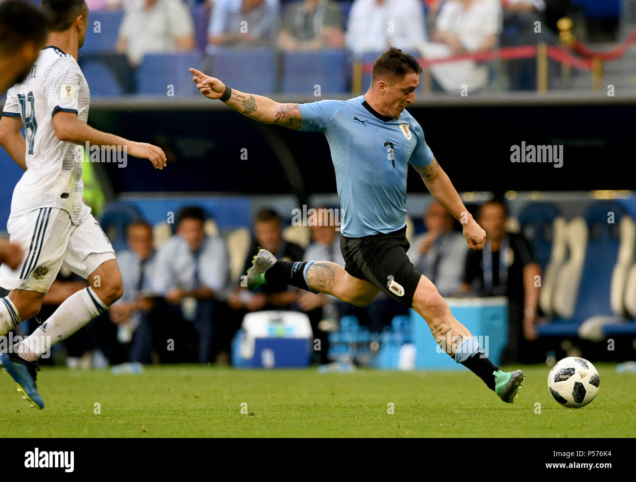 Samara, Russia. 25th June, 2018. Cristian Rodriguez (R) of Uruguay shoots during the 2018 FIFA World Cup Group A match between Uruguay and Russia in Samara, Russia, June 25, 2018. Uruguay won 3-0. Russia and Uruguay advanced to the round of 16. Credit: Du Yu/Xinhua/Alamy Live News Stock Photo