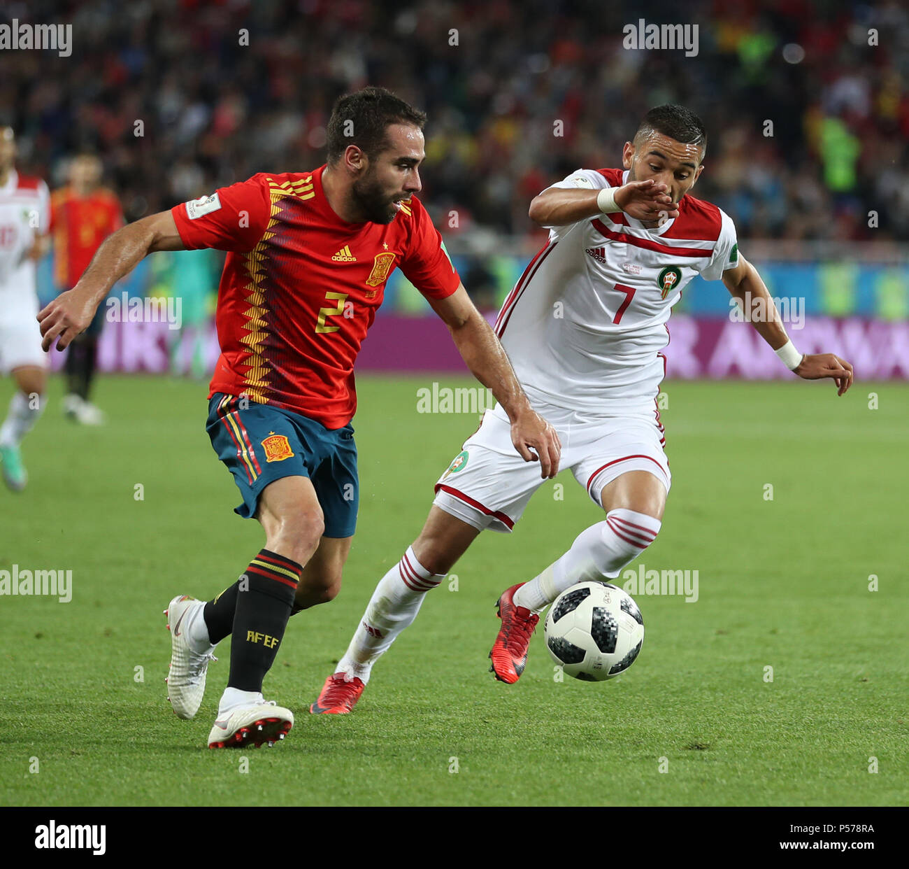 Kaliningrad, Russia. 25th June, 2018. Dani Carvajal (L) of Spain vies with Hakim Ziyach of Morocco during the 2018 FIFA World Cup Group B match between Spain and Morocco in Kaliningrad, Russia, June 25, 2018. Credit: Lu Jinbo/Xinhua/Alamy Live News Stock Photo