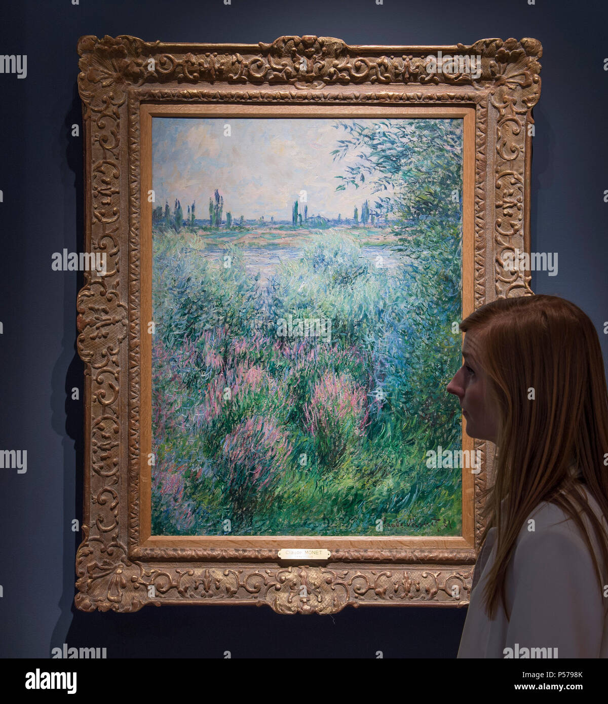 Masterpiece Art Fair, Royal Hospital Chelsea, London, UK. 25 June, 2018. Work is underway at Masterpiece London 2018 before the press opening on 27 June and public event 28 June - 4 July 2018. Fair Highlights in this major summer season event include Hammer Galleries with some extraordinary works by Monet, Renoir, Cassatt, Picasso, Chagall and Matisse. Photo: Bords de la Seine, un coin de berge, 1881. Claude Monet. Credit: Malcolm Park/Alamy Live News. Stock Photo