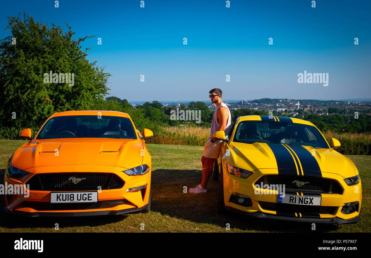 London, England. 25th June 2018. Two European, right hand drive Mustangs owned by father and son, Eugene Ring and Cameron Ring (in picture), in the sunshine of London's heatwave. It is said that this heatwave will continue into next week. Credit: Tim Ring/Alamy Live News Stock Photo