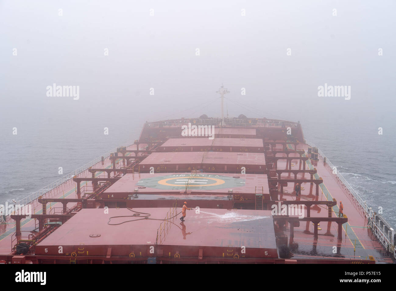 Quanzhou. 20th June, 2018. Sailors clean the deck on the freighter 'Jinhaifa', June 20, 2018. The freighter 'Jinhaifa' ships bulk coal between harbours in north China and Quanzhou in southeast China's Fujian Province. Seafarers on the freighter usually spend 6 to 8 months working and living on the sea then have two to four months' rest. June 25 marked the Day of the Seafarer. There had been 1.483 million registered seafarers in China by the end of 2017. Credit: Cai Yang/Xinhua/Alamy Live News Stock Photo