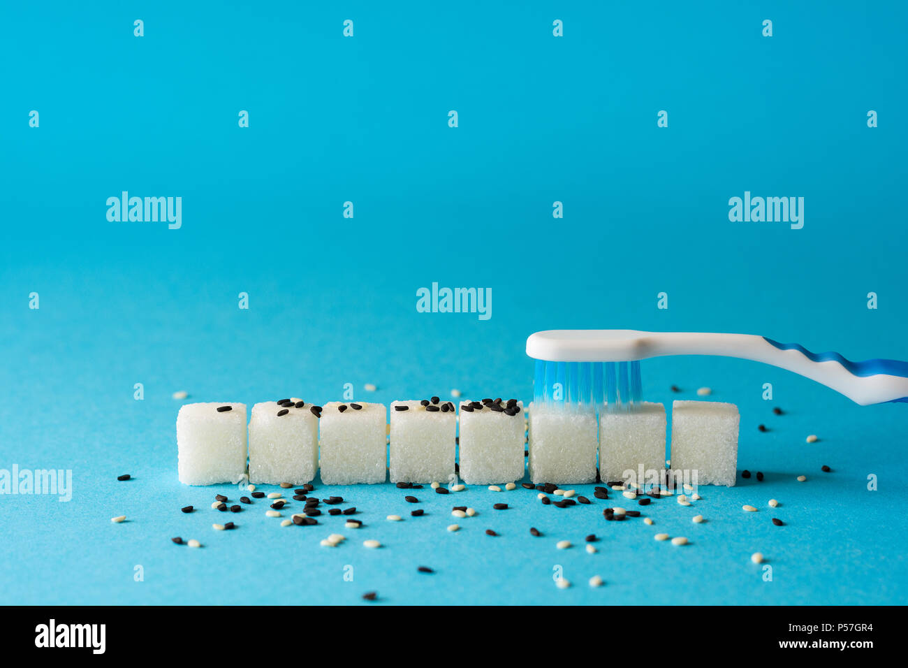 Brushing teeth. Toothbrush cleans dirt from teeth. Sugar cubes and