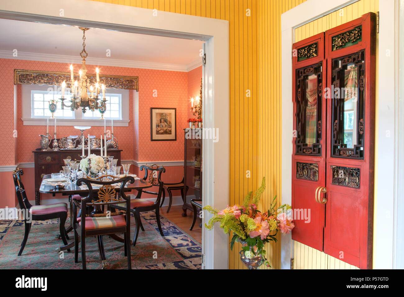 Dining room and front entry hall in a brightly colored residential home, United States. Stock Photo