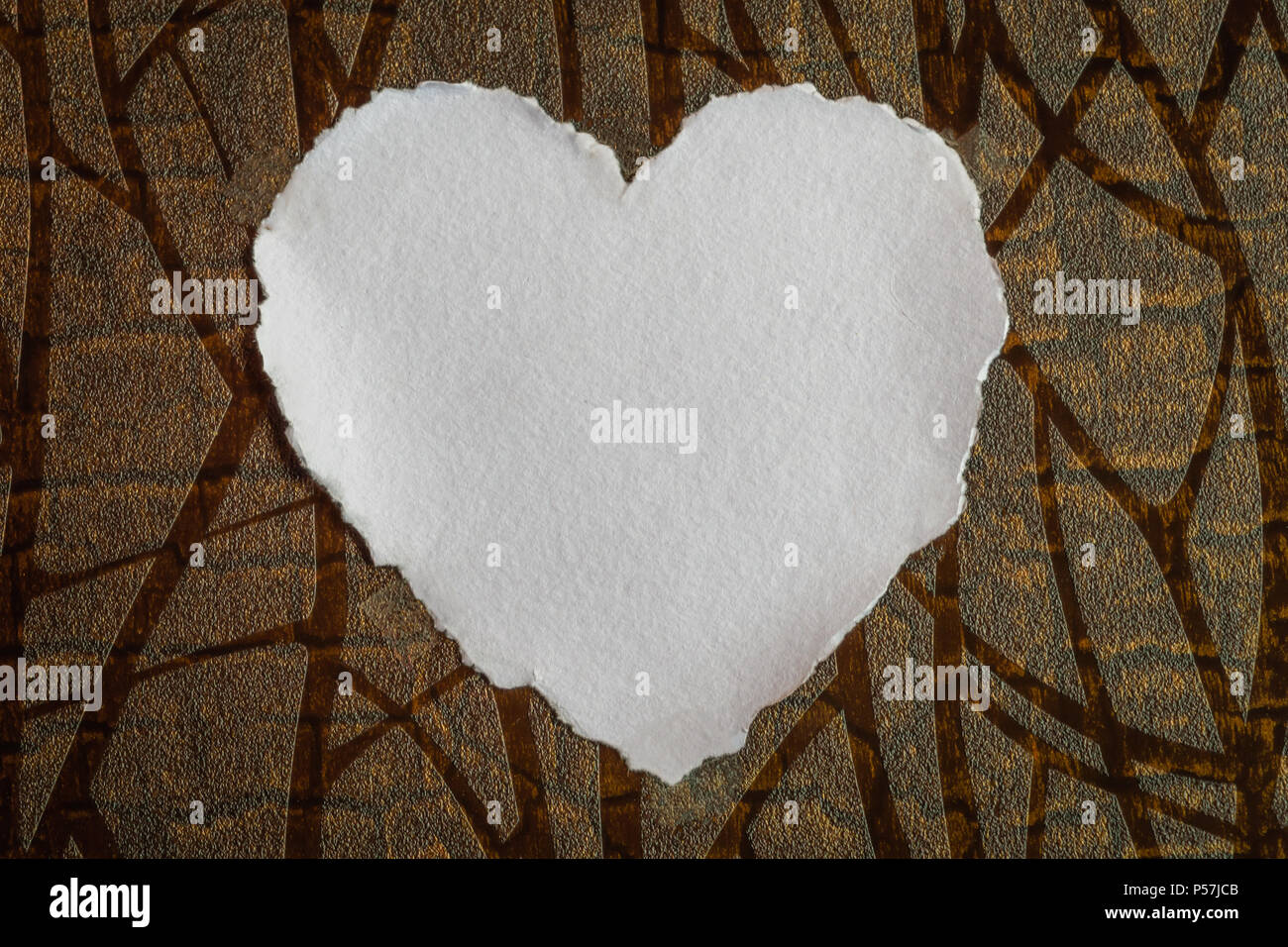 Heart shaped white sheet of paper on a textured background for love notes Stock Photo