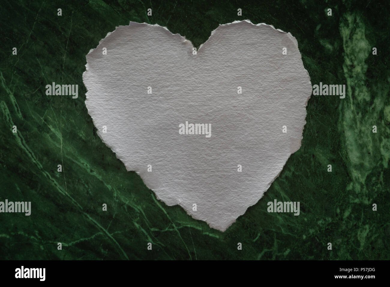 Heart shaped white sheet of paper on a marble background for love notes Stock Photo
