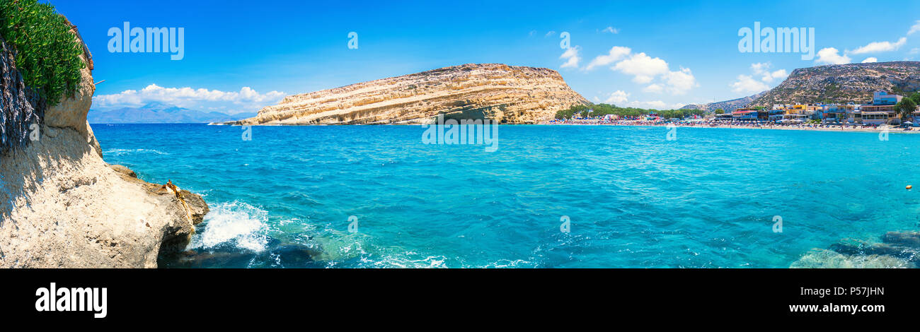 Matala beach with caves on the rocks that were used as a roman cemetery and at the decade of 70's were living hippies from all over the world, Crete, Stock Photo