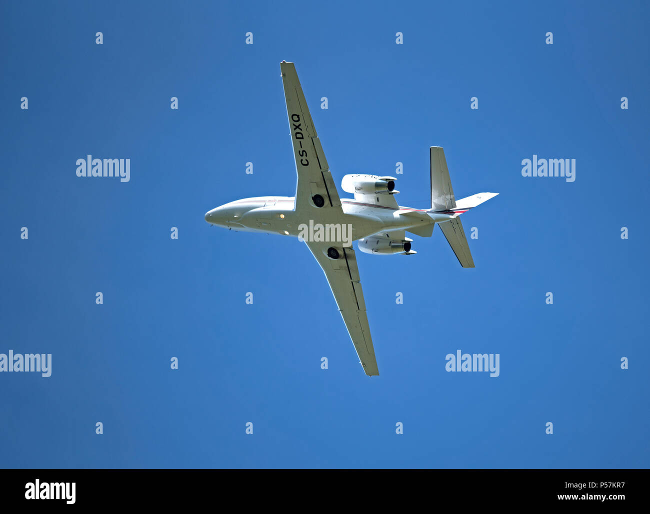 A Portuguese registered Cessna 560XL from Netjets Europe climbs swiftly  out from Inverness Dalcross Airport into a beautiful blue sky. Stock Photo