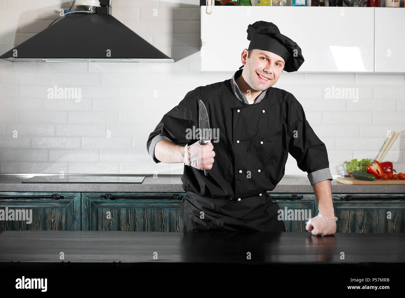 Man cook preparing food at the kitchen table of vegetables Stock Photo ...