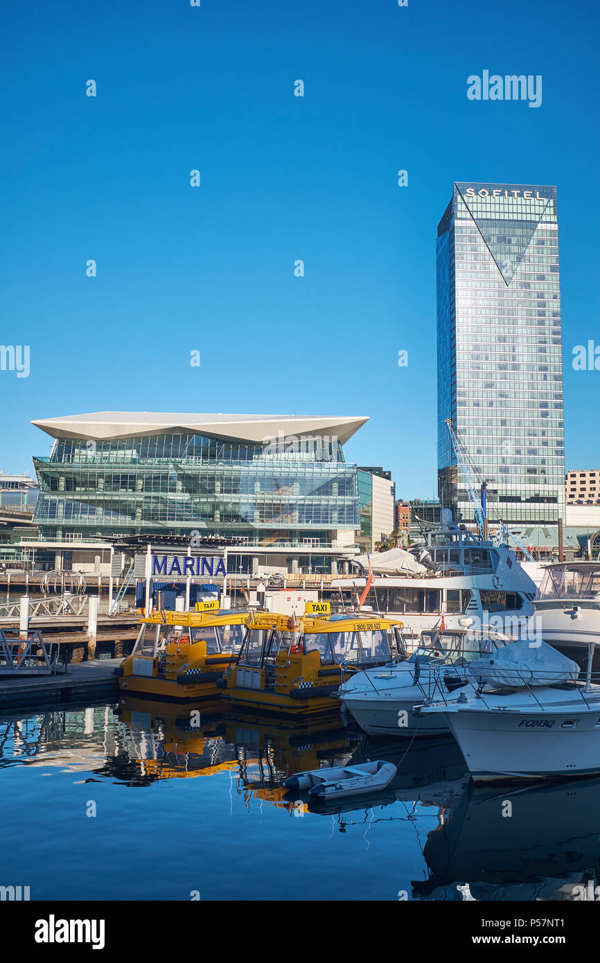 The ICC Sydney and the Sofitel Hotel from Cockle Bay Wharf with Darling Harbour Marina in the foreground on a bright cloudless sky morning Stock Photo