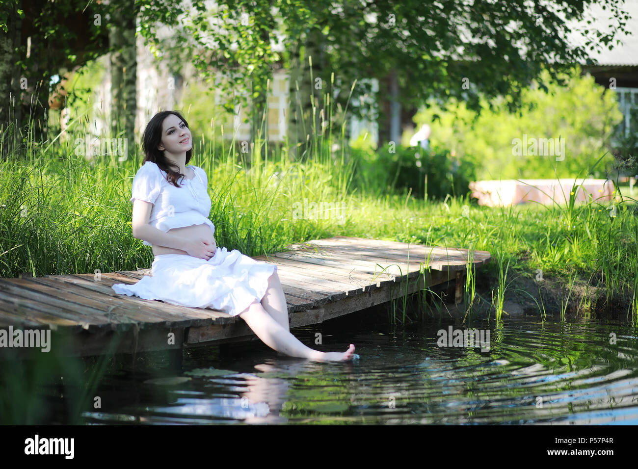 Pregnant woman in nature for a walk in the early summer Stock Photo - Alamy