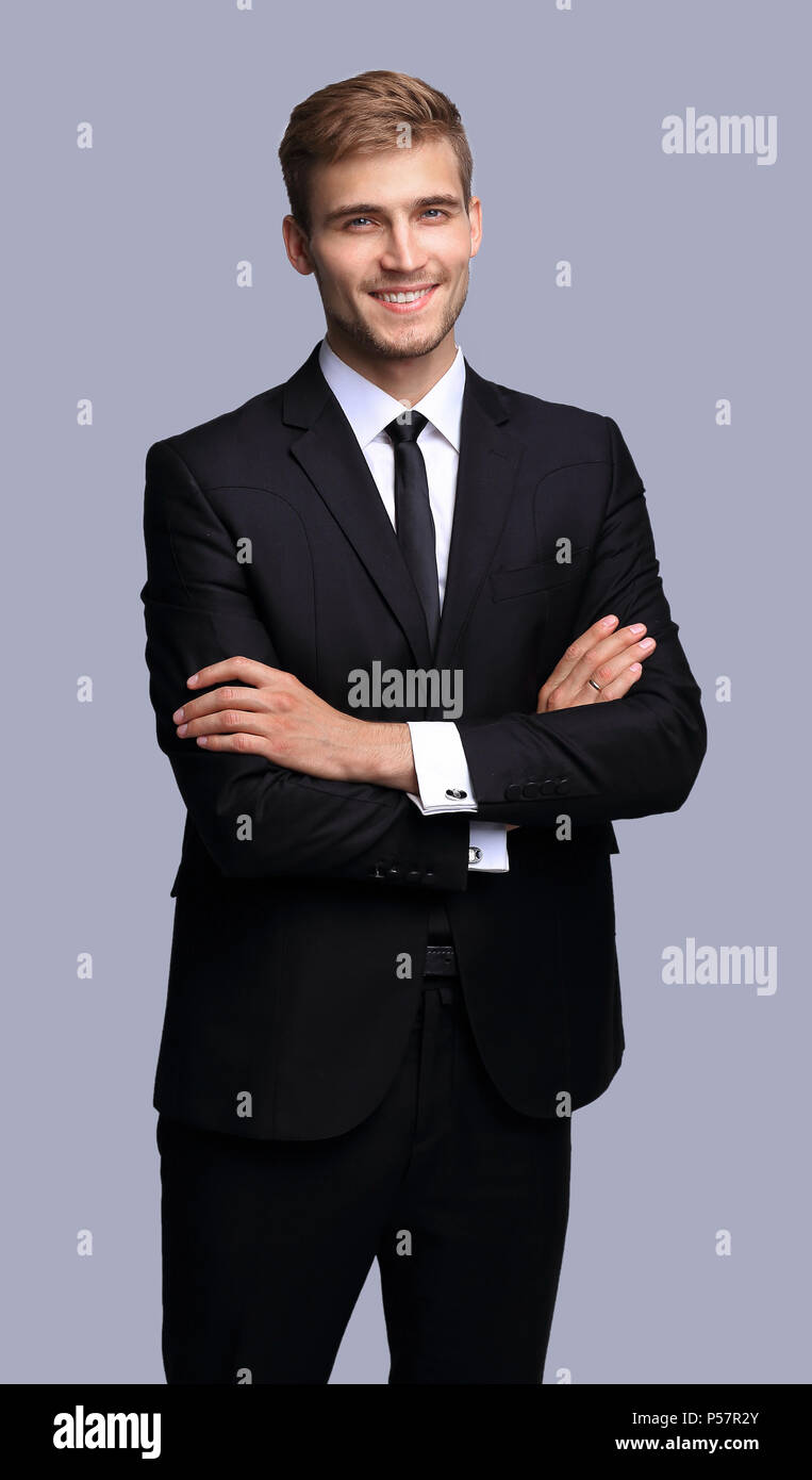 portrait in full growth. successful businessman with arms crossed in ...