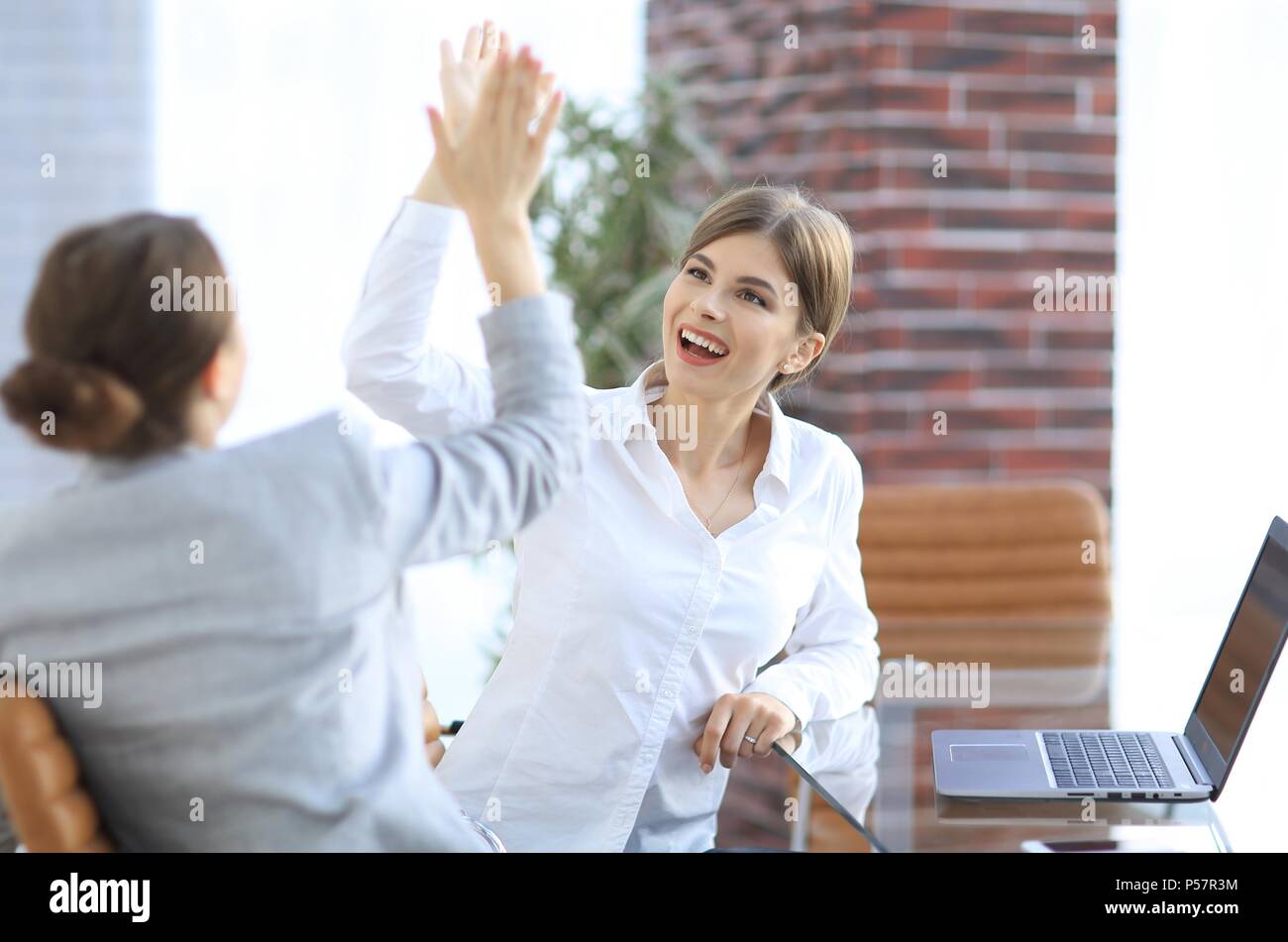 members of the business team giving each other a high five Stock Photo ...