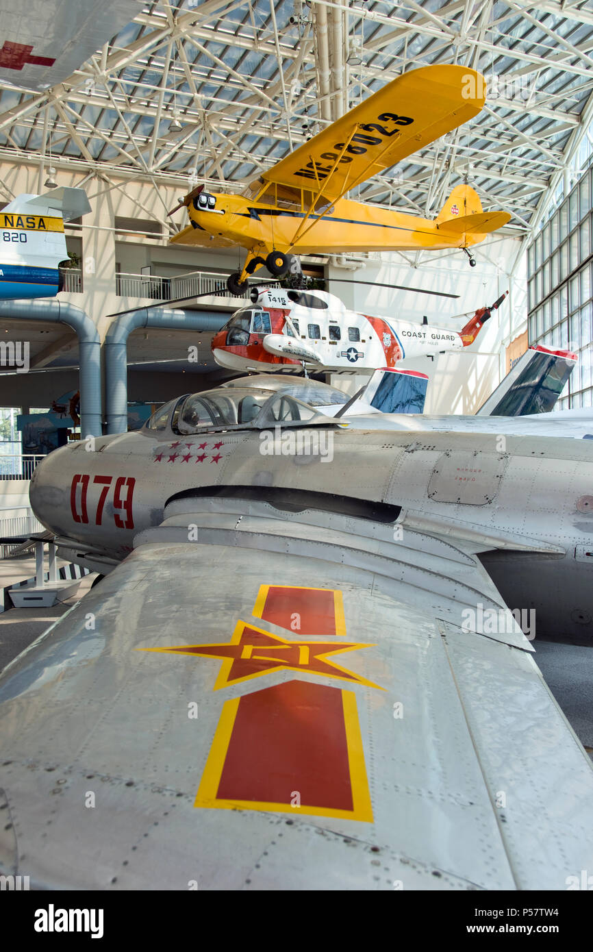 A 1950 MiG-15 jet fighter (painted for Chinese air force) and a Piper J3 Cub (above) at the Museum of Flight, Boeing Field, Tukwila, Washington. Stock Photo
