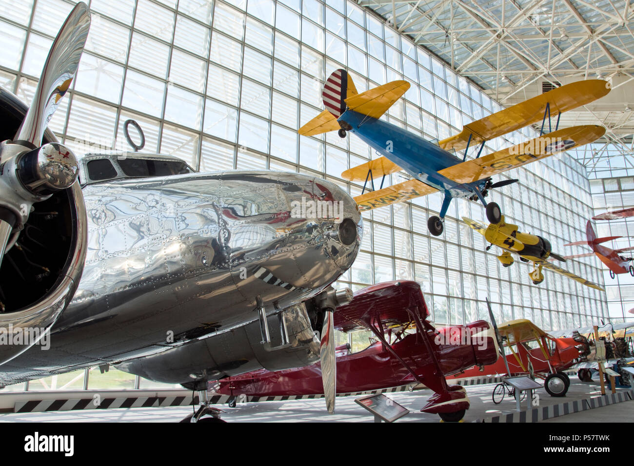 A Stearman PT-13A Kaydet  hangs above a 1935 Lockheed Model 10-E Electra (left), the type used by Amelia Earhart, at the Museum of Flight, Seattle, WA Stock Photo