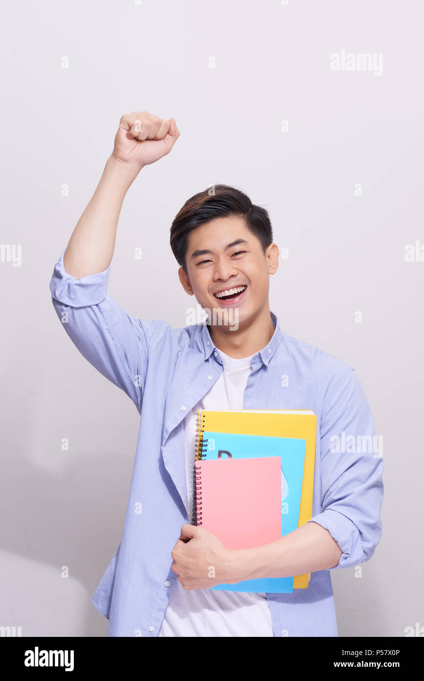 Confident asian handsome student holding books Stock Photo