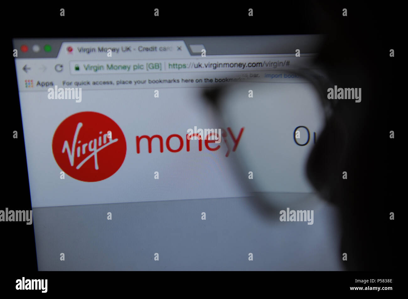 A person looks at the Virgin Money website Stock Photo