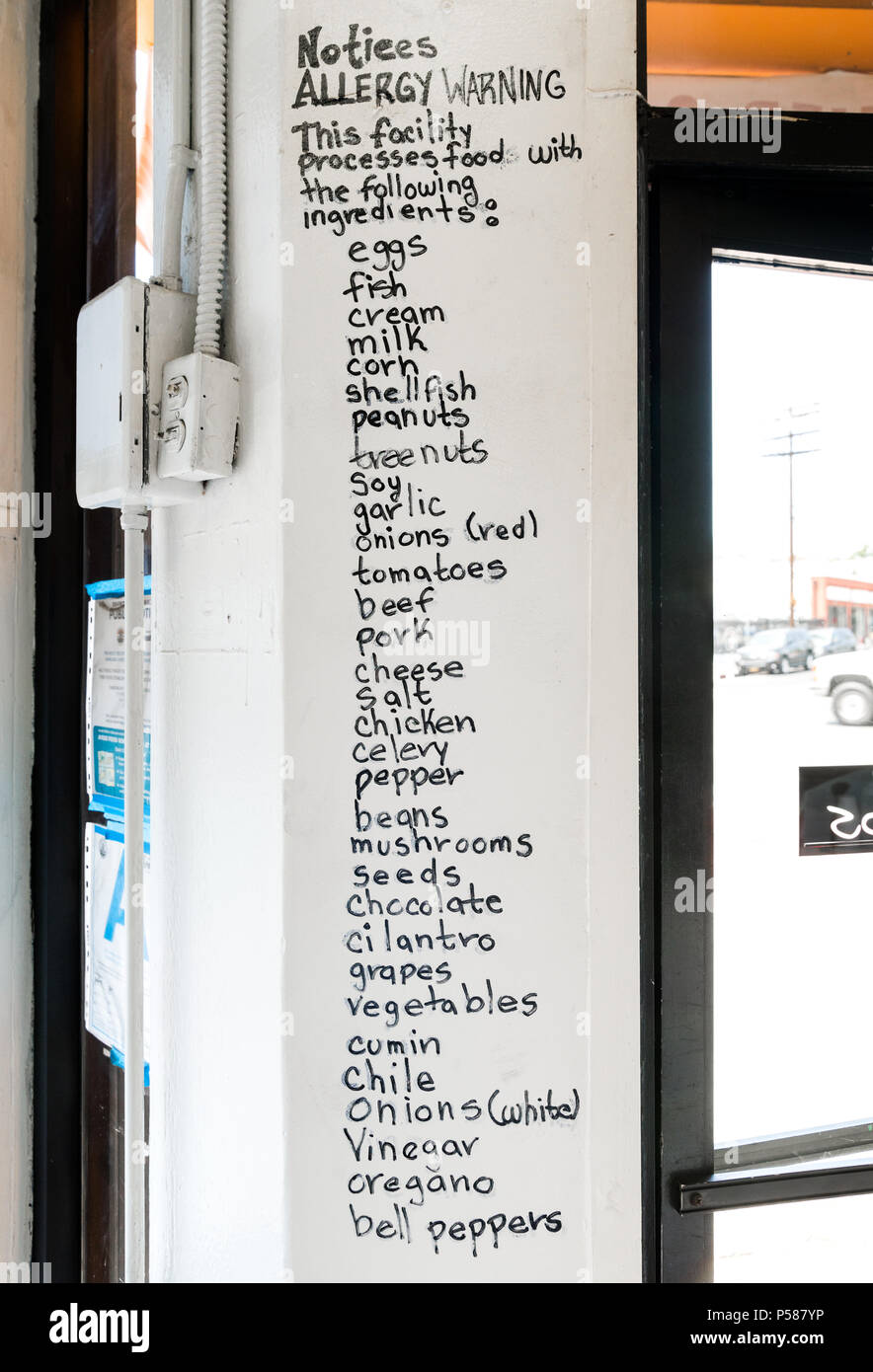 Handwritten allergy warning: list of ingredients used by restaurant. Stock Photo