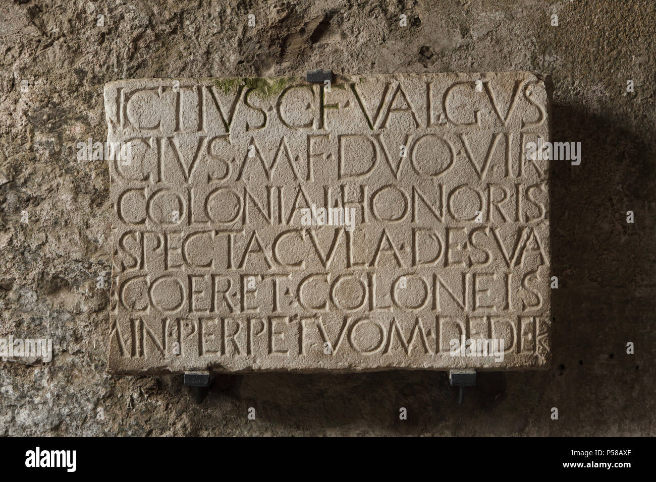 Marble plaque with Latin dedication placed at the South entrance to the Roman amphitheatre in the archaeological site of Pompeii (Pompei) near Naples, Campania, Italy. The plaque records that Quinctius Valgus and Marcus Porcius, who were duumvirs or magistrates of Pompeii, had erected the amphitheatre at their own expense. Stock Photo
