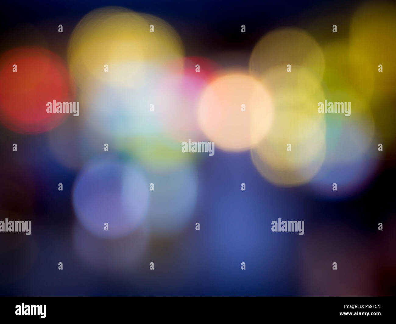 Background formed by blurred reflections of colored lights Stock Photo