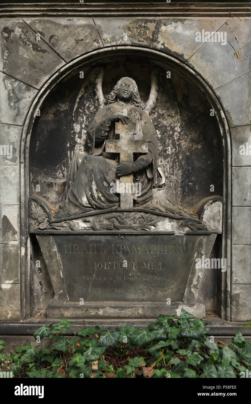 Abandoned grave of Russian doctor Ivan Kramarenko at Olšany Cemetery in Prague, Czech Republic. Ivan Kramarenko was a doctor of Prague nobility and died on 2 February 1844. The Empire funeral monument on his grave by Bohemian sculptor František Linn depicts an angel holding an orthodox cross. Stock Photo