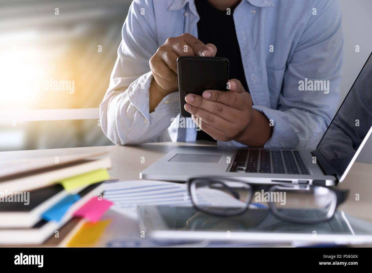 businessman using phone smart phone and notebook computer Stock Photo