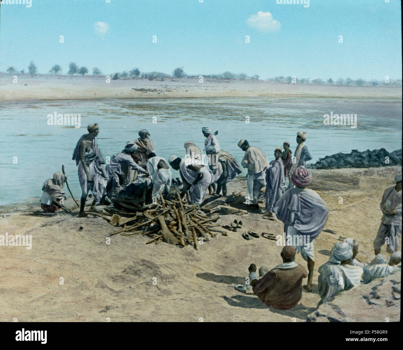 Corpse on Pyre, Hindu Funeral, Lower Ganges, Uttar Pradesh, India, Hand-Colored Magic Lantern Slide, Newton & Company, 1930 Stock Photo