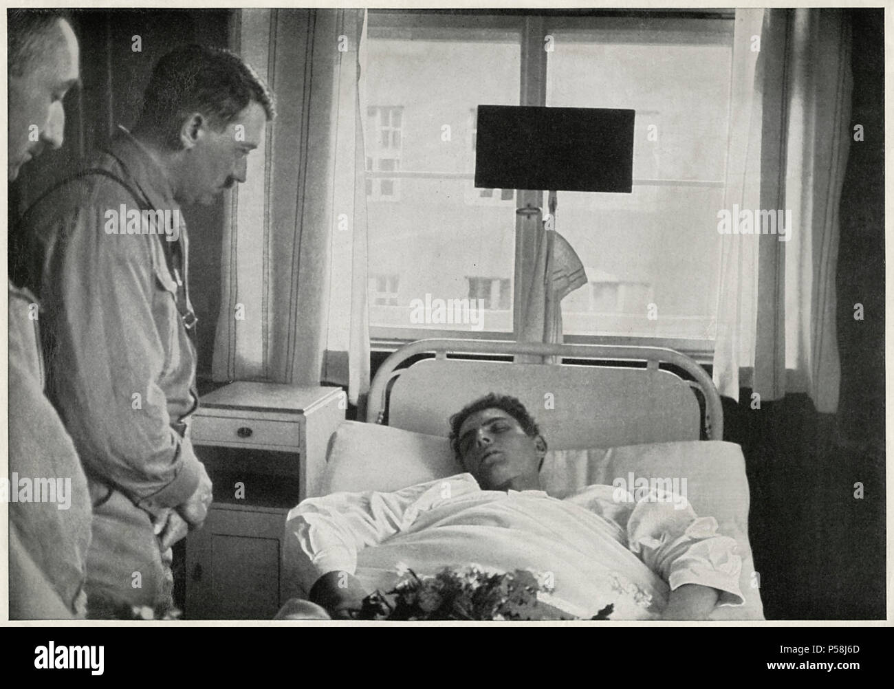 Adolf Hitler visiting Injured Man in Hospital, Germany, 1931 Stock Photo
