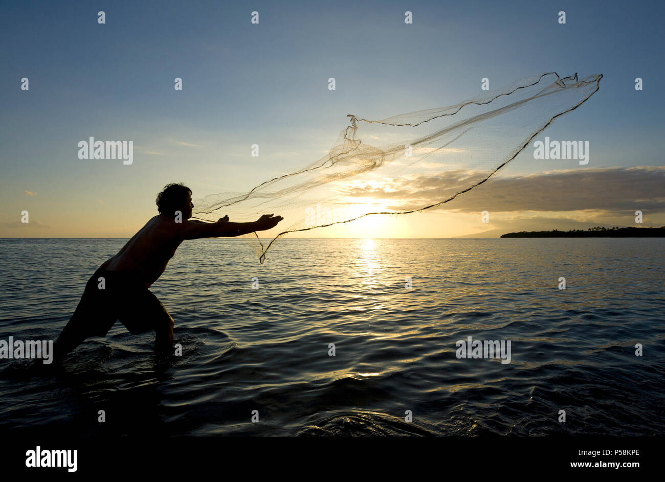 Hawaiian fisherman throws net at sunset at Olowalu, Maui, Hawaii