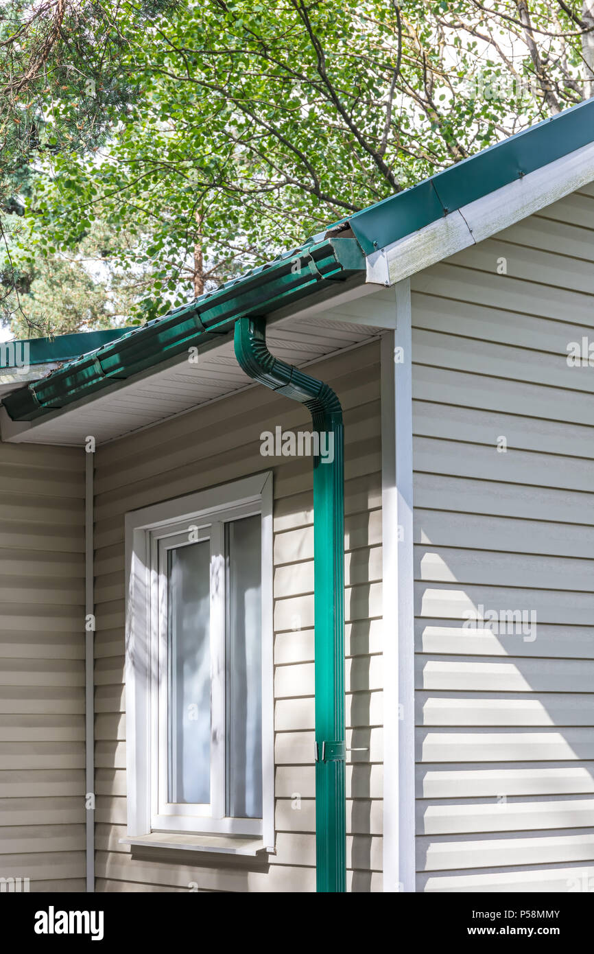 Corner Of House With Gutter And Green Metal Tiling Roof Stock Photo Alamy