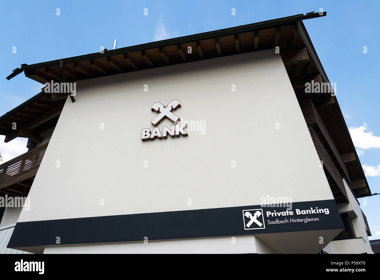 SAALBACH-HINTERGLEMM, AUSTRIA - JUNE 21 2018: Raiffeisen Bank company logo on branch building on June 21, 2018 in Saalbach-Hinterglemm, Austria. Stock Photo
