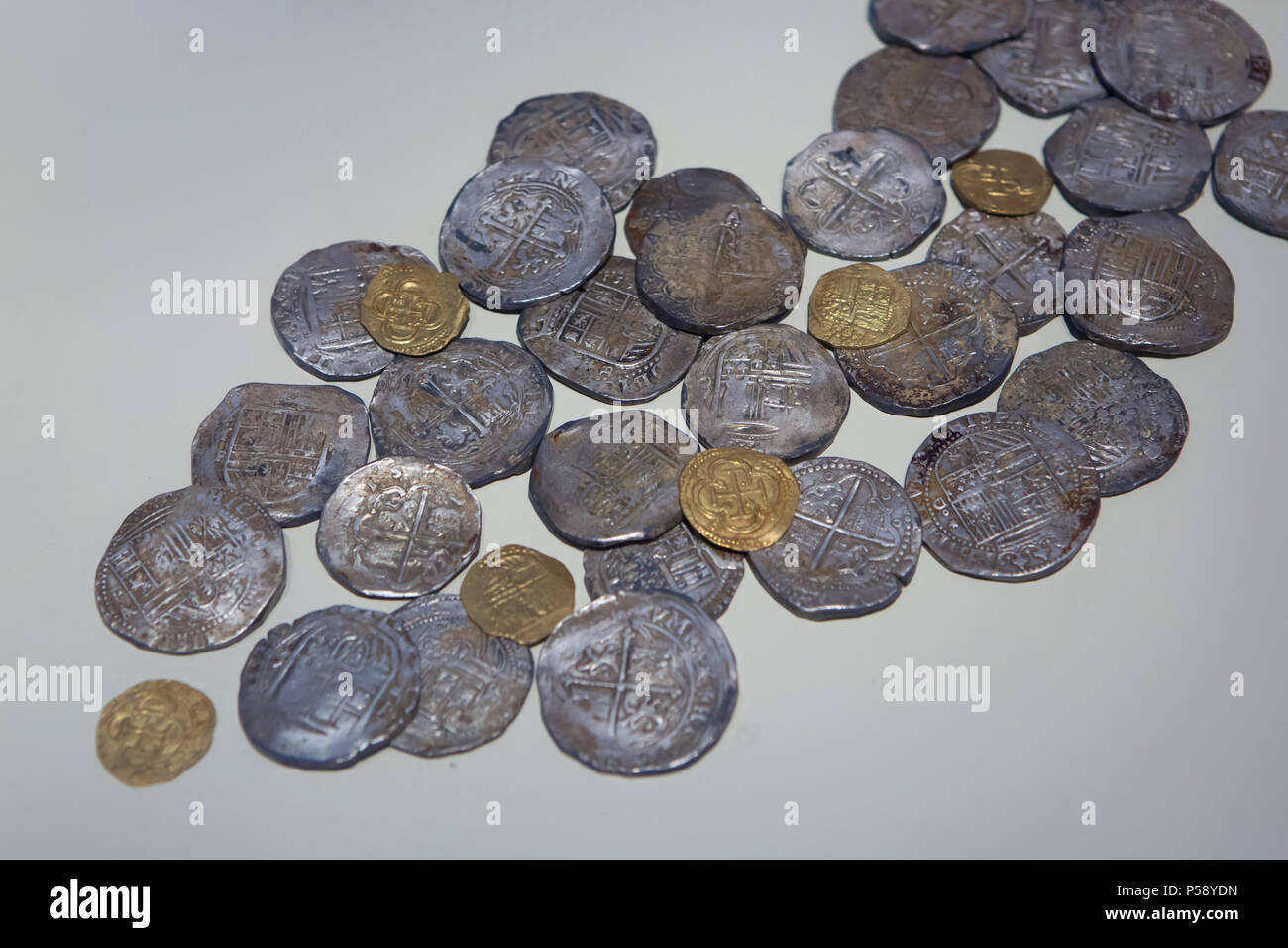 Spanish silver and golden coins from the Gazteluberri Hoard (Tesoro de Gazteluberri) on display in the National Archaeological Museum (Museo Arqueológico Nacional) in Madrid, Spain. Hoard of 52 silver and gold coins of Queen Joanna, King Charles V and King Philip II issued in 1537-1598 was found in Segura in Guipúzcoa Province, Spain. Stock Photo