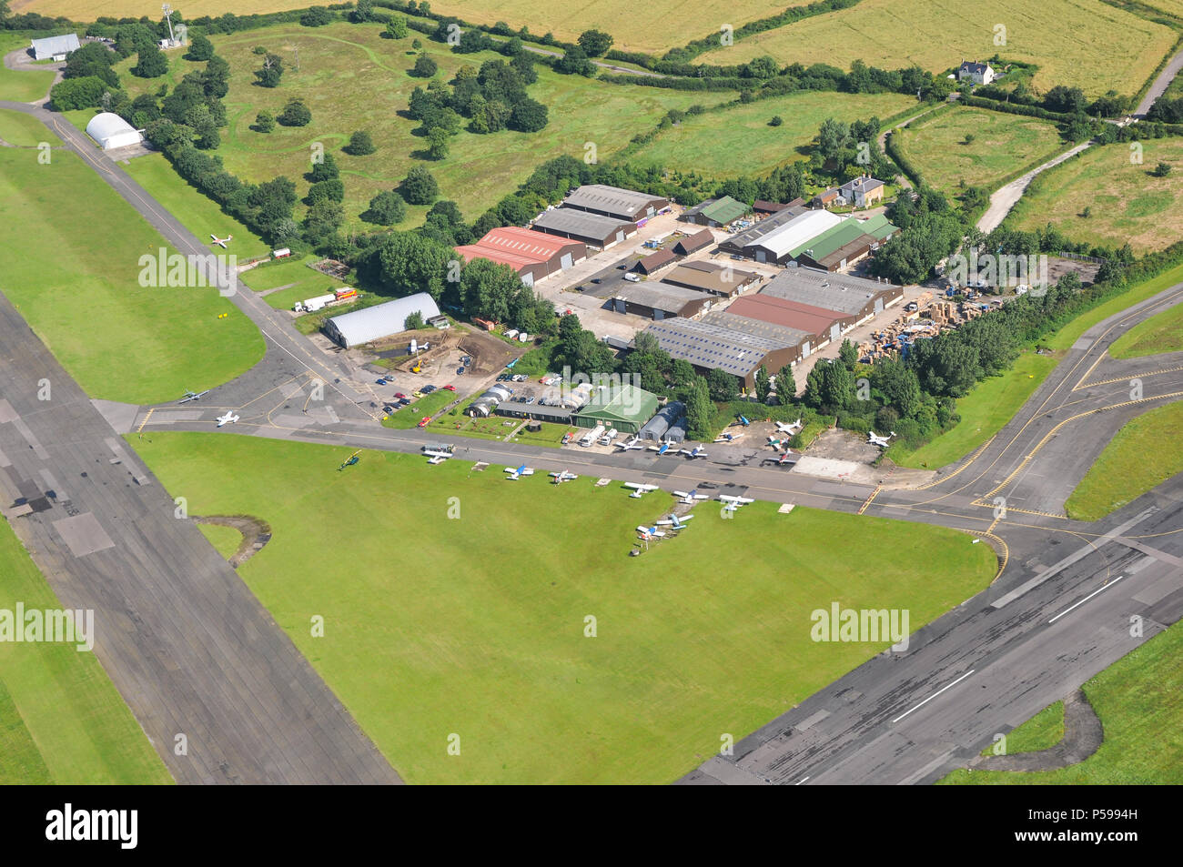 North Weald airfield aerial photograph. The Squadron cafe restaurant, hangars, aircraft and taxiways. Essex, UK. Second World War historic aerodrome Stock Photo