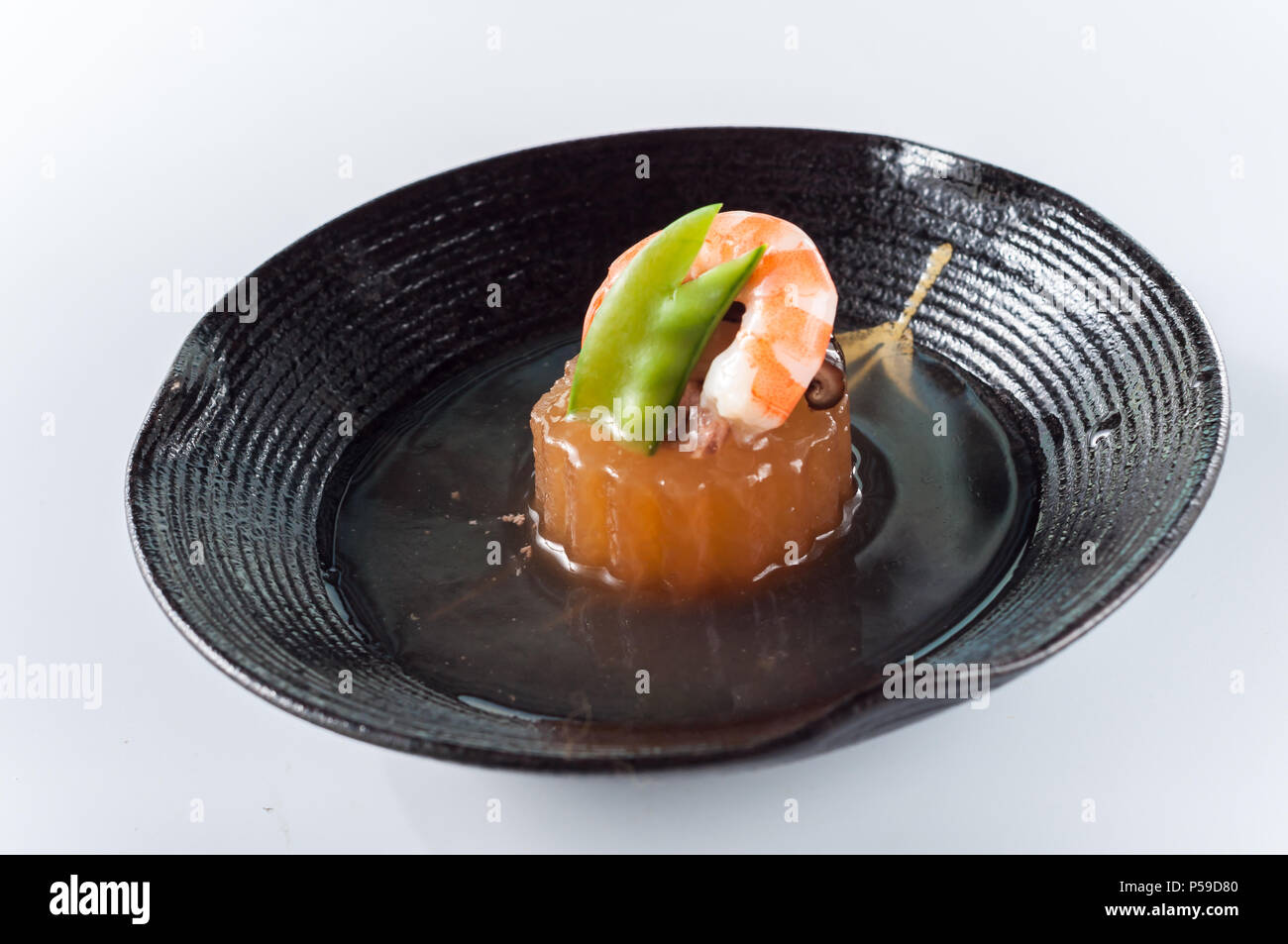Foie gras, shrimp, mushrooms, peas in the black plate,kaiseki Stock Photo