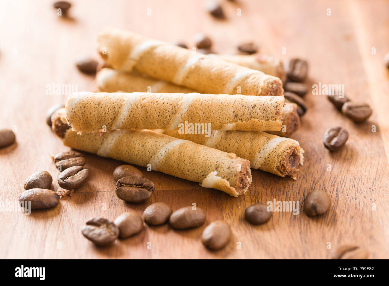 Sweet chocolate waffle rolls and coffee beans. Stock Photo