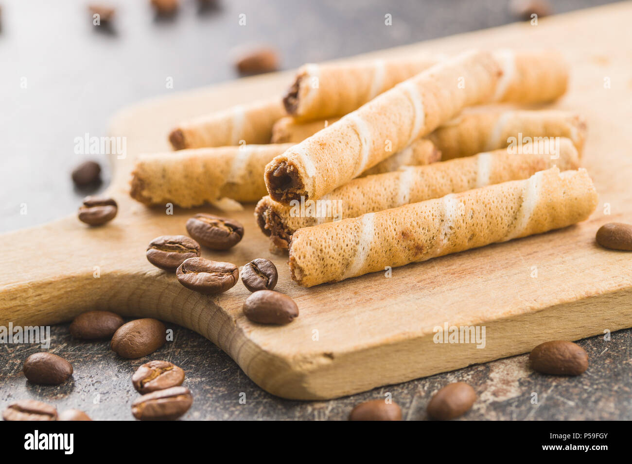 Sweet chocolate waffle rolls and coffee beans. Stock Photo