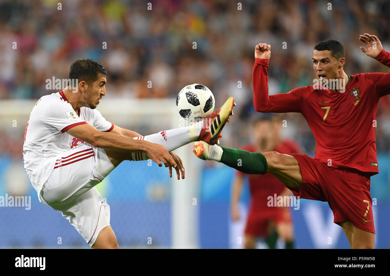 Saransk, Russia. 25th June, 2018. Soccer: FIFA World Cup 2018, Iran vs Portugal, group stages, group B, 3rd matchday, Saransk Stadium: Majid Hosseini (L) from Iran and Cristiano Ronaldo from Portugal vie for the ball. Credit: Andreas Gebert/dpa/Alamy Live News Stock Photo