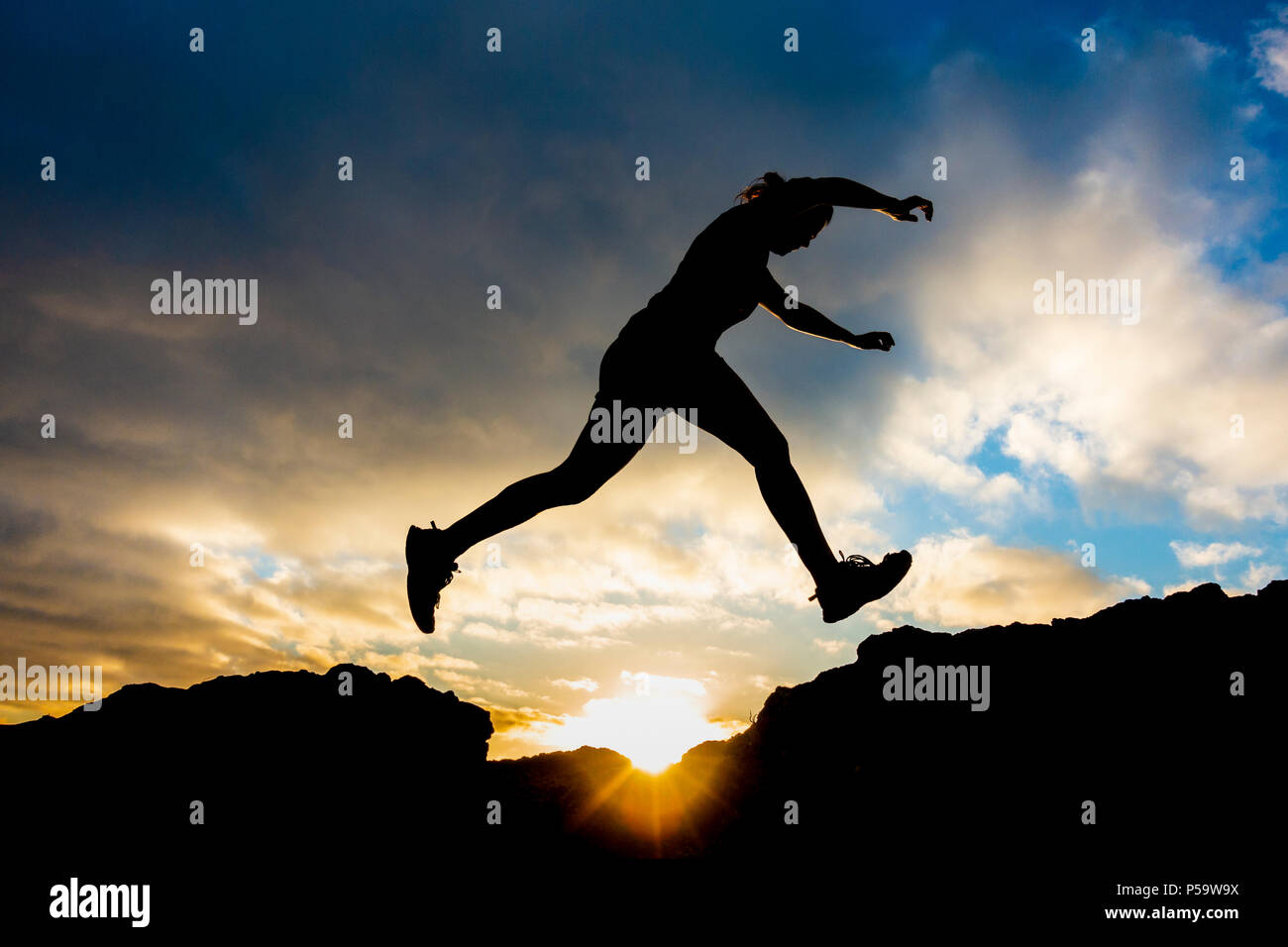 Female trail runner on mountain summit at sunrise Stock Photo - Alamy