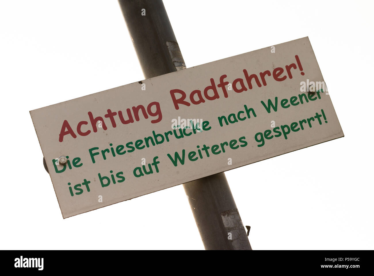 Germany, Weener. 20th June, 2018. A sign warn cyclists of the damaged railway bridge in Weener. Credit: Mohssen Assanimoghaddam/dpa/Alamy Live News Stock Photo