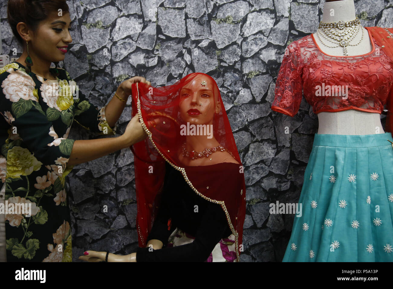 June 26, 2018 Kathmandu, Nepal A woman arranges bridal wear on a