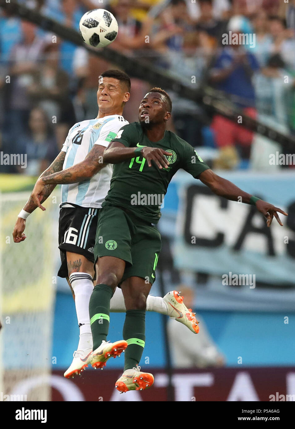 Saint Petersburg, Russia. 26th June, 2018. Kelechi Iheanacho (R) of Nigeria competes for a header with Marcos Rojo of Argentina during the 2018 FIFA World Cup Group D match between Nigeria and Argentina in Saint Petersburg, Russia, June 26, 2018. Credit: Wu Zhuang/Xinhua/Alamy Live News Stock Photo