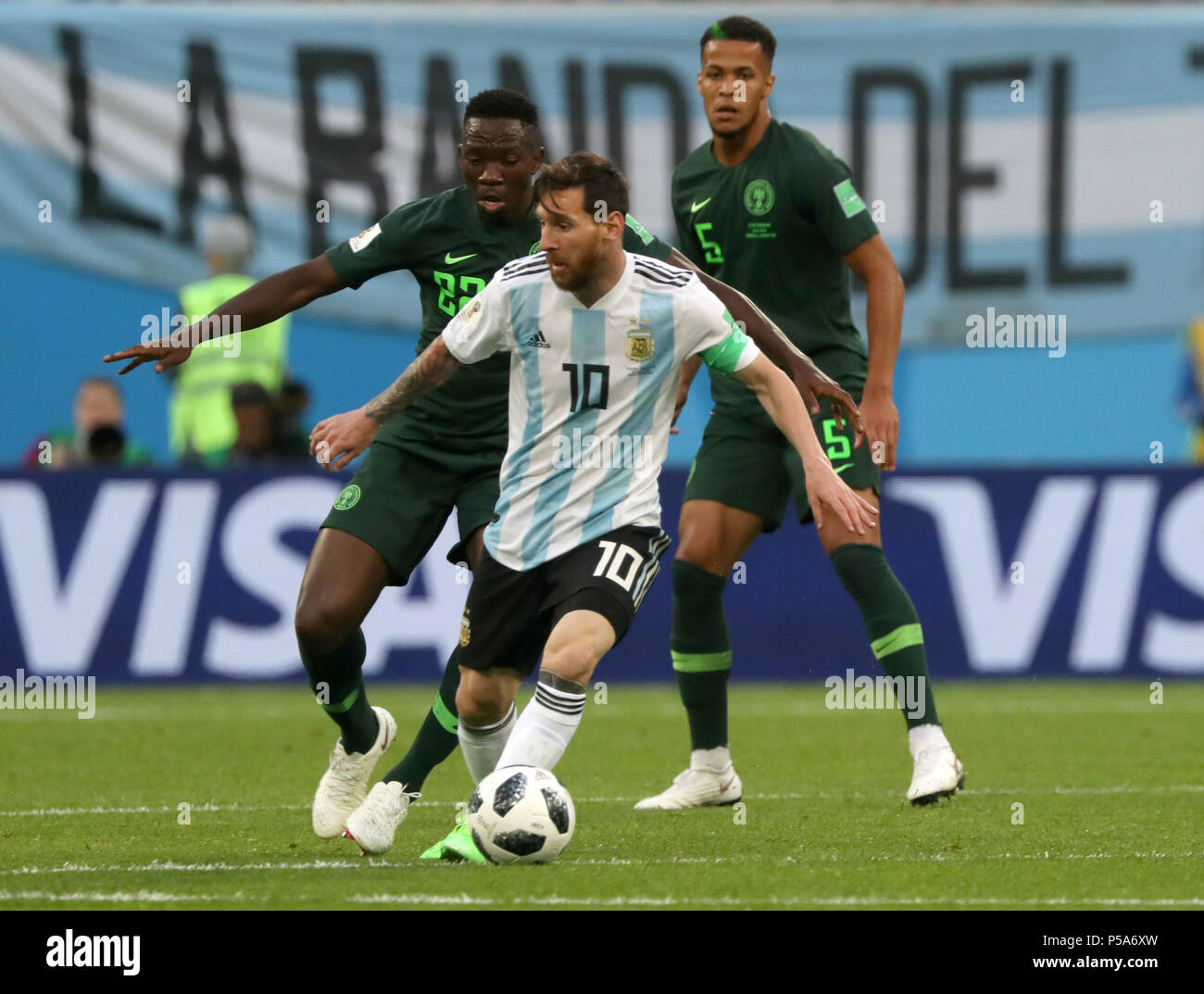 Moscow, Russia. 26th June, 2018. Soccer, World Cup 2018, Preliminary round, Group D, 3rd game day, Nigeria vs Argentina at the St. Petersburg Stadium: Argentina's Lionel Messi (C) and Nigeria's Kenneth Omeruo (L) vie for the ball. Credit: Cezaro De Luca/dpa/Alamy Live News Stock Photo