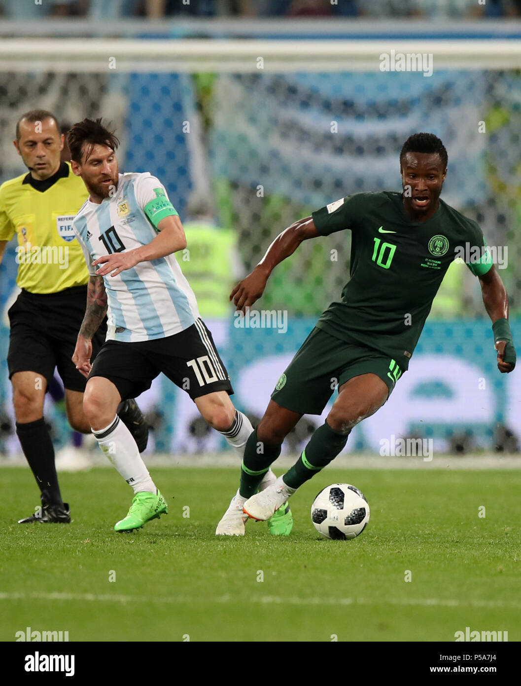 Saint Petersburg, Russia. 26th June, 2018. John Obi Mikel (R) of Nigeria vies with Lionel Messi (C) of Argentina during the 2018 FIFA World Cup Group D match between Nigeria and Argentina in Saint Petersburg, Russia, June 26, 2018. Credit: Wu Zhuang/Xinhua/Alamy Live News Stock Photo