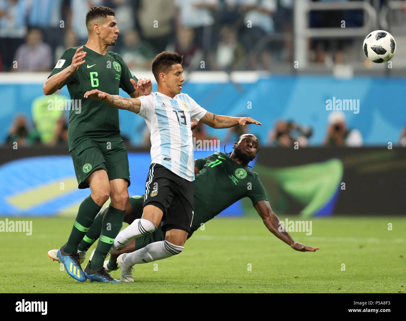 Saint Petersburg, Russia. 26th June, 2018. Victor Moses (R) of Nigeria vies with Maximiliano Meza (C) of Argentina during the 2018 FIFA World Cup Group D match between Nigeria and Argentina in Saint Petersburg, Russia, June 26, 2018. Argentina won 2-1 and advanced to the round of 16. Credit: Yang Lei/Xinhua/Alamy Live News Stock Photo