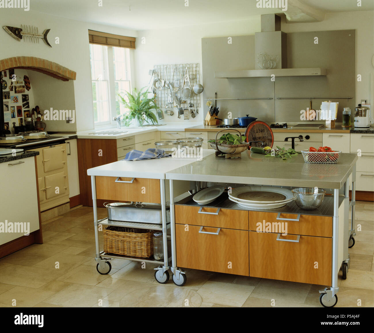 Large moveable island unit on castors in modern white kitchen with