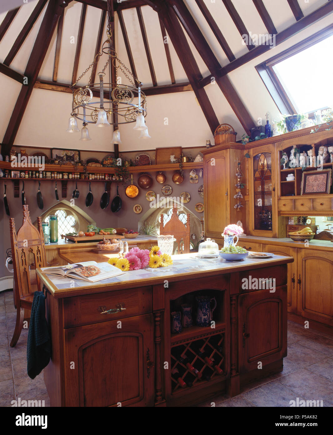 Dark wood island unit in Victorian style kitchen in converted church Stock Photo