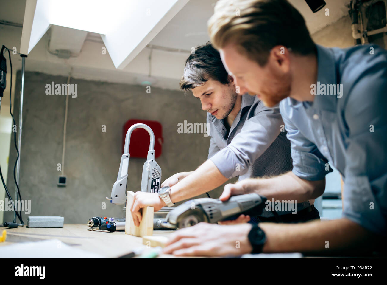 Two creative designers working in workshop Stock Photo