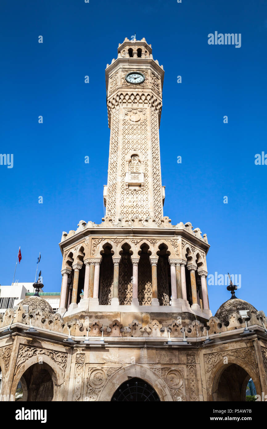 Facade of clock tower under blue sky, it was built in 1901 and accepted as the official symbol of Izmir City, Turkey Stock Photo