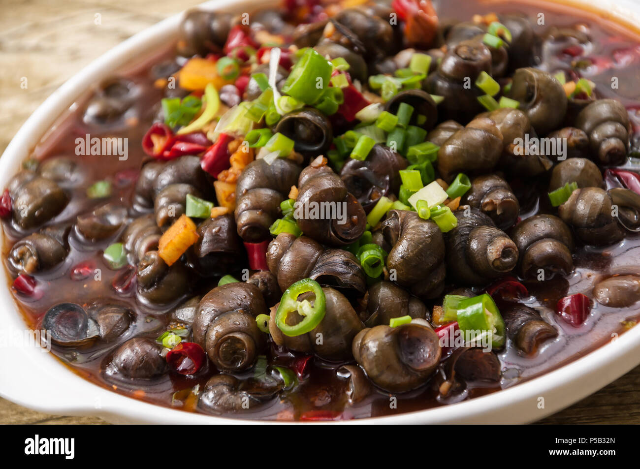 field snail stir fried with chili sauce, a popular chinese dish Stock ...