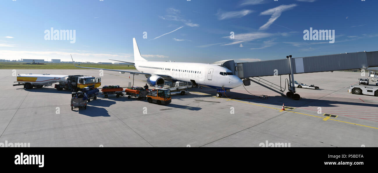 ground staff handling of an aircraft before departure at the airport - refueling and baggage and security checks Stock Photo
