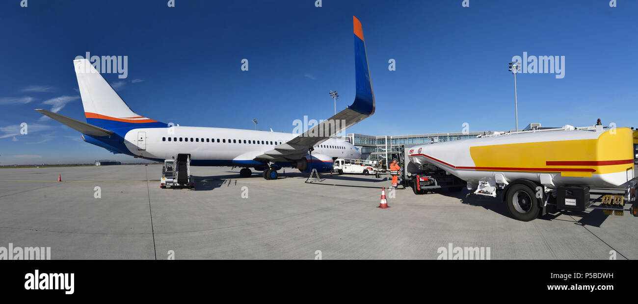 ground staff handling of an aircraft before departure at the airport - refueling and baggage and security checks Stock Photo